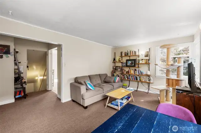 Living room looking to stairwell and kitchen