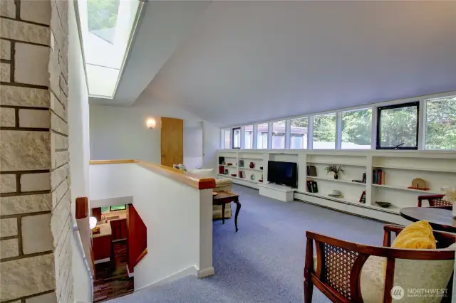 Top of the stairs opens to rec room with built in book shelves!