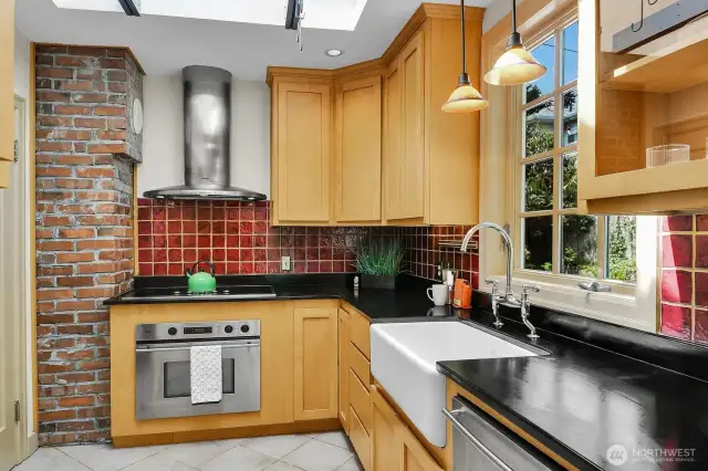 Carefully designed kitchen with skylight, paperstone counters and view of the back patio.