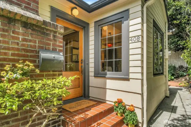 Refinished oak entry door and leaded glass windows.