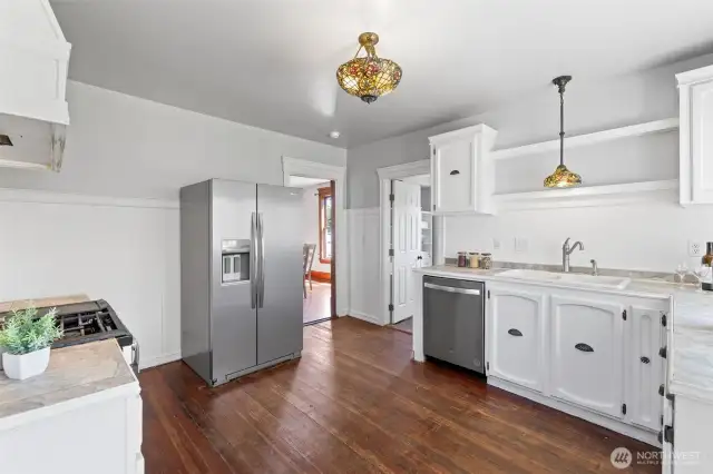 Kitchen looking toward dining room and full bathroom.  Not shown on the left is the door to the utility room where the furnace and on-demand water heater are located.