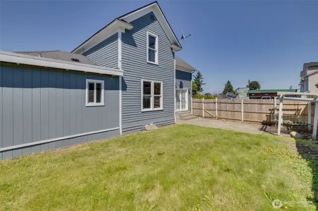 South-facing side yard with patio, showing doors from living room to access the patio.