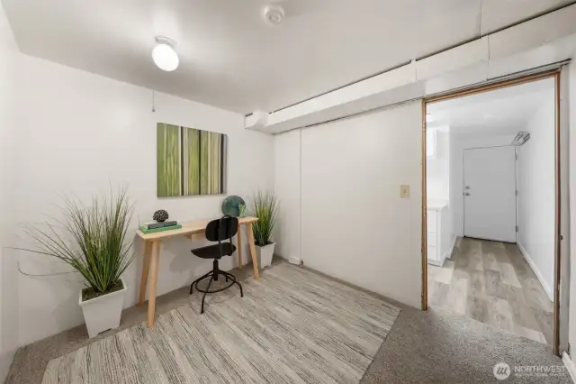 This lower-level room is staged as a home office but offers flexibility for a variety of uses, from a workout space to a guest room. Neutral finishes and a quiet setting make it a functional extension of the main living areas.