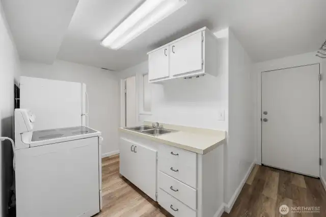 The lower-level second kitchen includes a full-size range, sink, and storage, offering functional space for meal prep or extended living. With a private exterior entrance, it presents a great opportunity for ADU potential or multi-generational living.