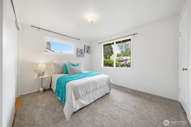 Bedroom Two, features a large front-facing windows in this bedroom provide a clear view of the yard. The layout includes a two spacious closet and wall to wall carpet for everyday comfort.