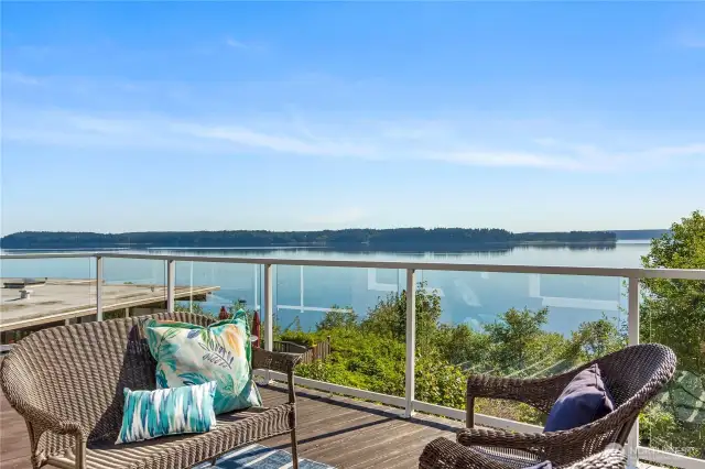 180 degree views of the Puget Sound from your own massive deck where you can enjoy panoramic scenes of the shimmering water, distant islands, and the majestic Olympic Mountains.