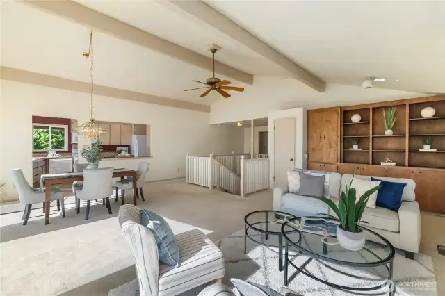 Living room has classic built-in cabinets.  A guest bath and the primary suite are on the main level just beyond the stairwell.