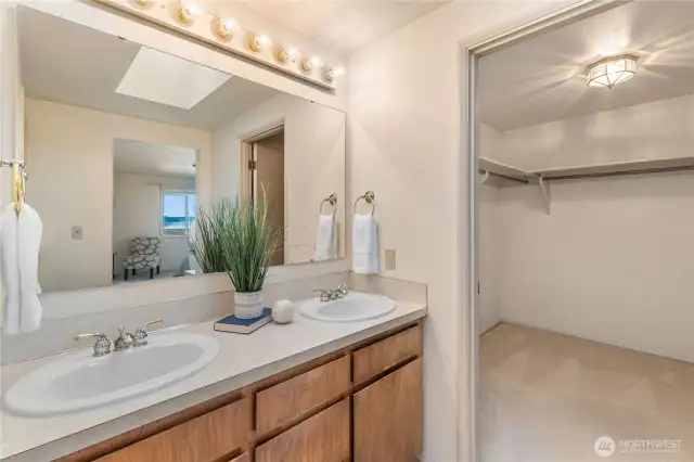 A walk-in closet is to the right of the primary duel sinks.