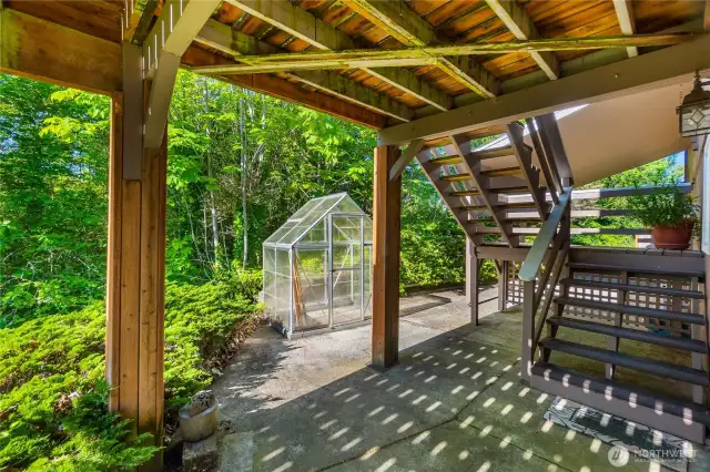 A green house is perfect for the gardeners that like to get an early start!  The stairs lead to the expansive upper deck.