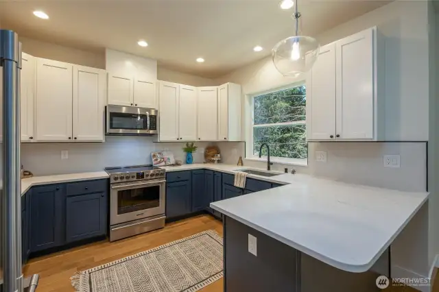 Kitchen with shaker cabinets and quartz countertops