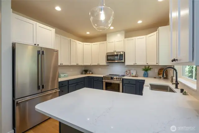 Kitchen with shaker cabinets and quartz countertops