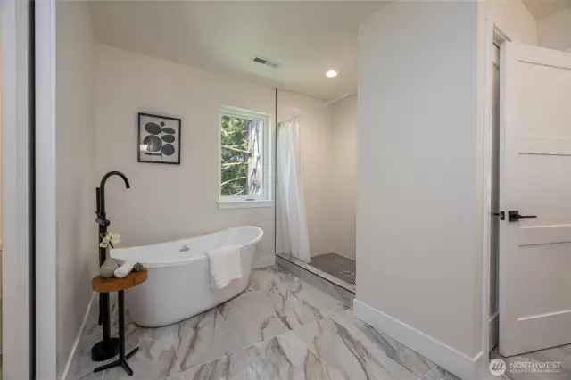 Primary bathroom with soaking tub and shower.