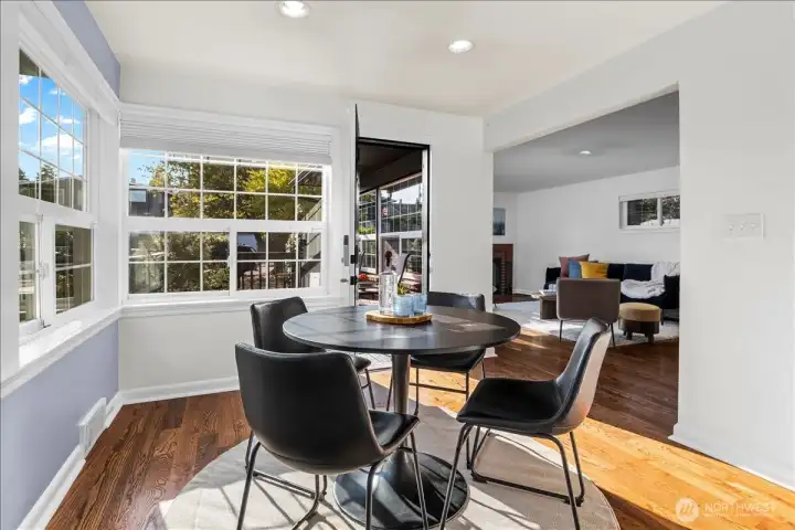 Dining room is nestled between kitchen, spacious deck and living room so everyone can gather and feel welcome.