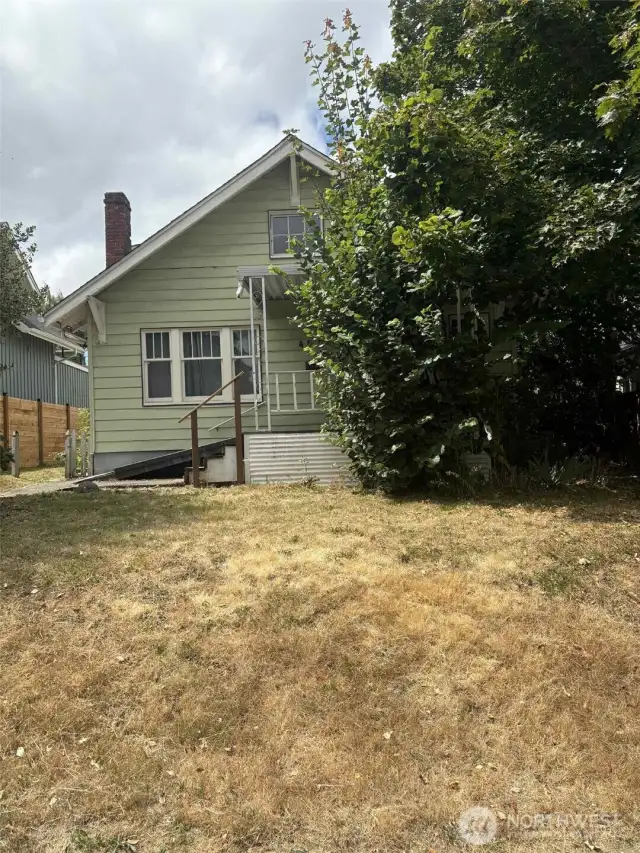 Set back off the street, with a beautifully restored home next door, this home could be next! SO much potential!