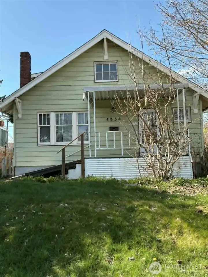 Featuring classic architecture, a covered front porch, and original windows, it’s ready for someone with vision to restore its warmth and character.