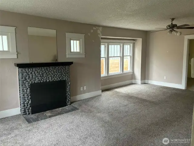 The living room opens directly to the dining area, the original windows are abundant in this space.