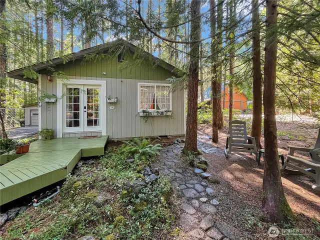 Cozy sitting area nestled next to a charming cobblestone path—perfect for relaxing moments.