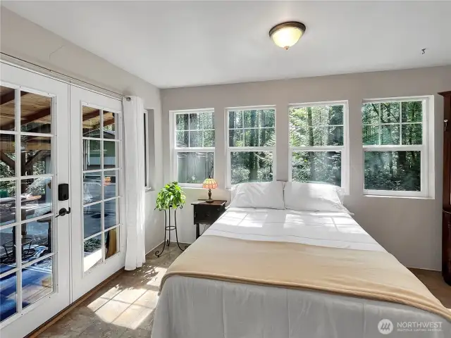 Sun-filled bedroom retreat with stunning windows & French doors.