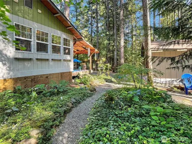 Meander along the winding garden path in the peaceful backyard.