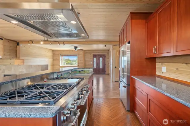 Kitchen with high end 6 burner gas range and granite counters. High end wood cabinetry too!