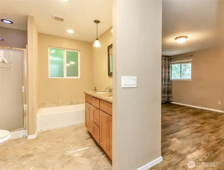 Primary bath has marble floors and separate tub and shower.