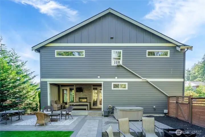 Covered patio with Fireplace  for all year round enjoyment! Fire Pit, Hot Tub, Seating area's , Garden space on the other side of the house  & barbecue area outside of picture to the right.