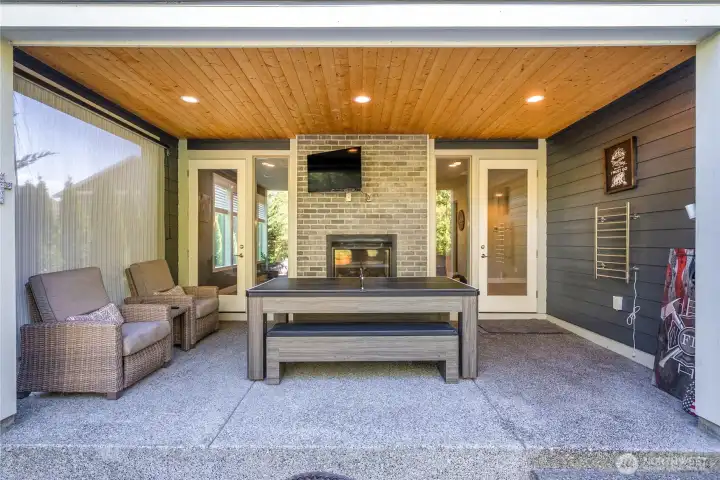 Back Patio with pool table/ping pong table/ dinner table, TV and a towel warmer for after a dip in the hot tub on a crisp fall evening!
