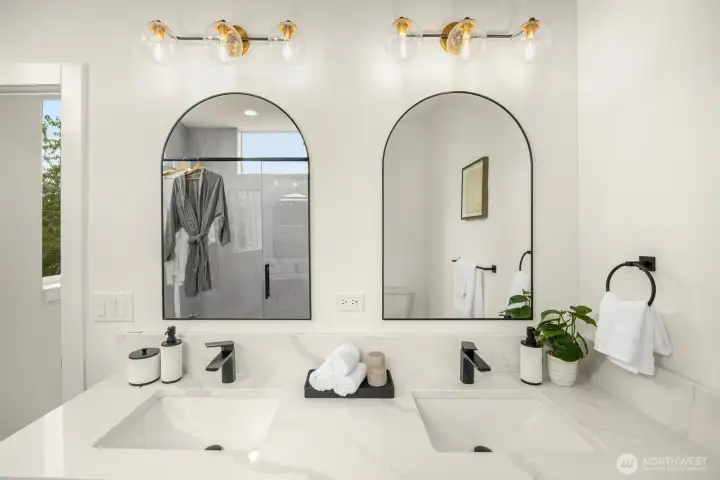 Modern simplicity meets quiet luxury in this spa-inspired bath with double vanities and soft, natural hues.