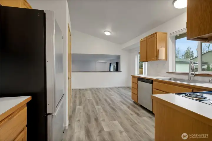 Kitchen with eating space and open connection to adjacent dining and living areas.