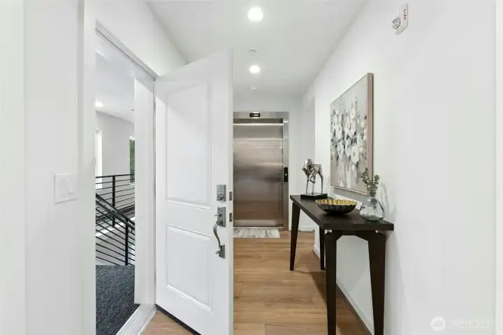 Showing the hallway entrance & the elevator entrance directly into the home.