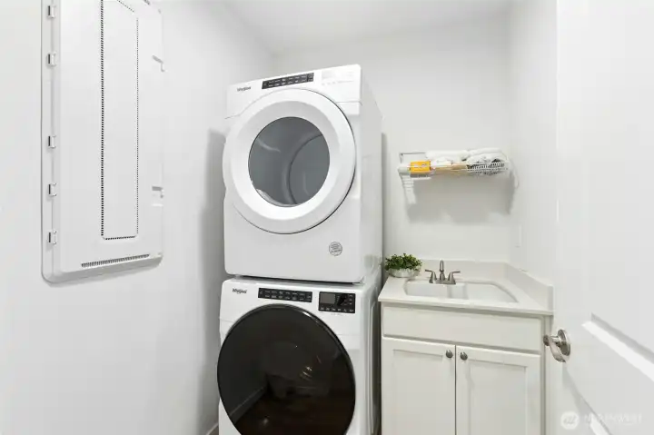 Well appointed laundry room with utility sink.