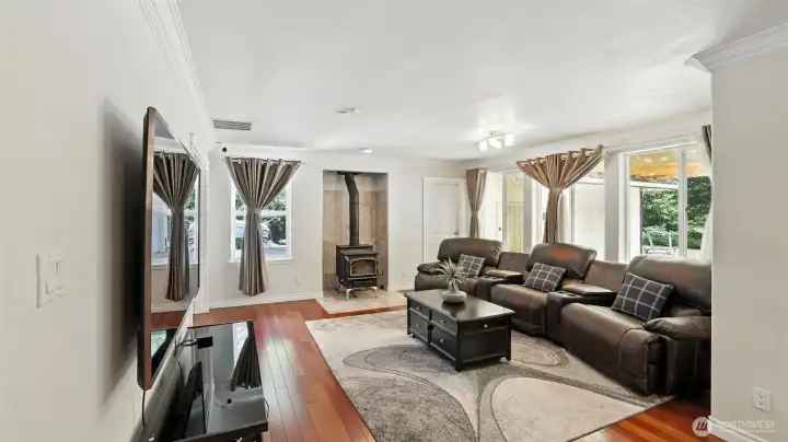 Spacious family room with fireplace and wall of windows.