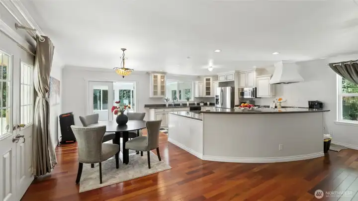 Chef’s kitchen with crisp white cabinetry and stainless appliances.