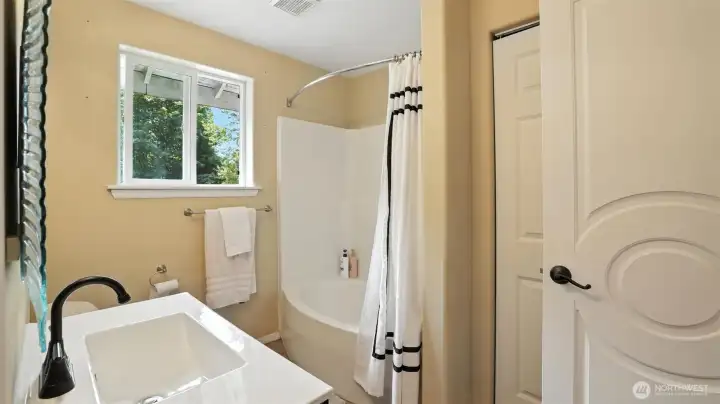 Full bath with tub/shower combo.