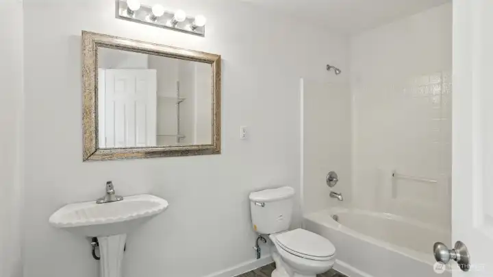 Full bath with tub/shower combo.