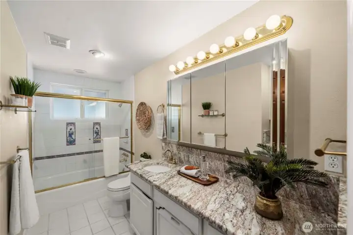 Beautiful full bath with/ Marble countertops & tiled bath