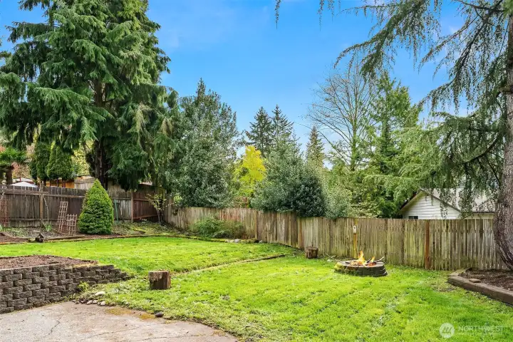 Large backyard space, with garden beds, firepit area and more!