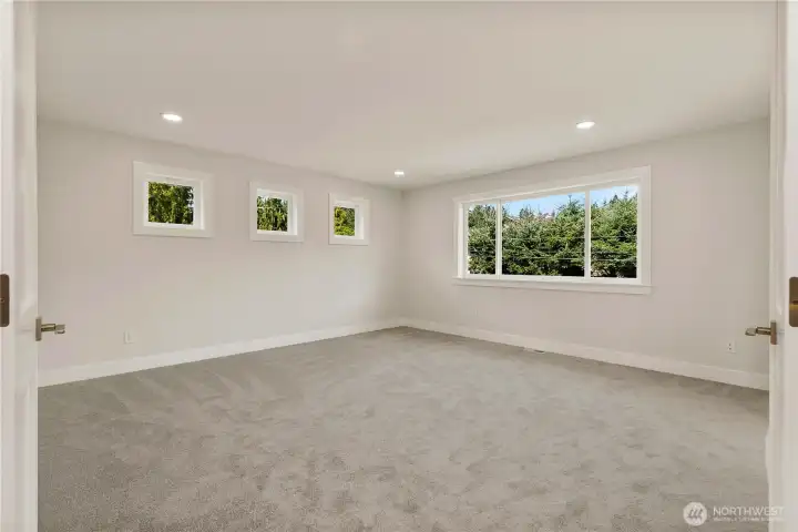 Double doors lead to a generous, light-filled primary suite retreat