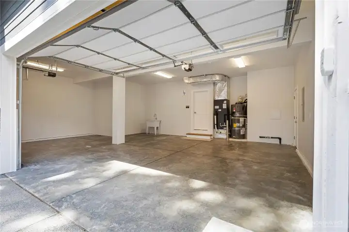 Oversized 725sq ft insulated three-car garage, complete with EV charging and a dedicated utility sink.