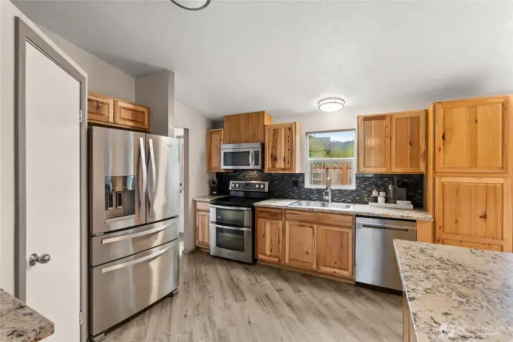 Kitchen with Stainless Appliances & Granite Countertops (partially digitally stage)