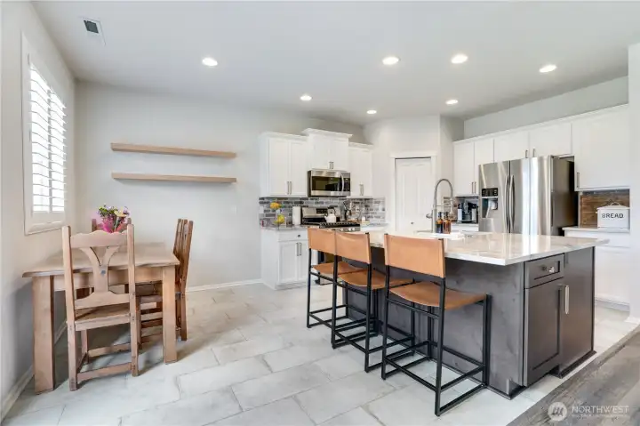 This kitchen was fully renovated this year. Real stone floors, large 6’x5’ island with custom quartz countertops are finishings that far exceed standard builder grade finishings.