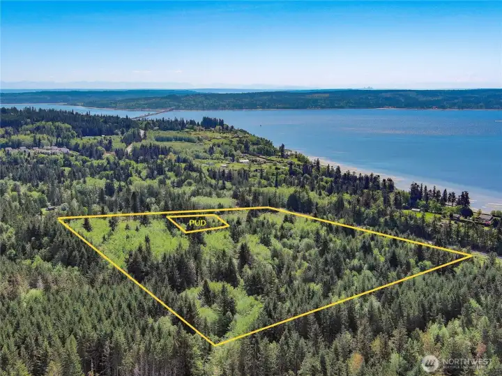 View facing East with the Hood Canal Bridge at top left. Potential views of the Cascade Mtn range and the Hood Canal from several locations on the site. View facing East with the Hood Canal Bridge at top left. Potential views of the Cascade Mtn range and the Hood Canal from several locations on the site.