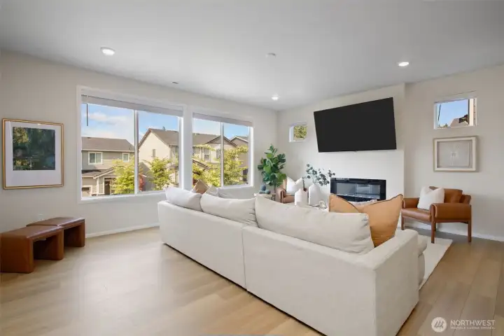 Open floor plan flooded with natural light designed for art or wall-mounted TV above fireplace feature. Open floor plan flooded with natural light designed for art or wall-mounted TV above fireplace feature.