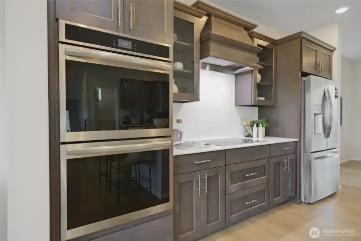 Chef's kitchen with double oven, induction range, and stainless appliances. Chef's kitchen with double oven, induction range, and stainless appliances.