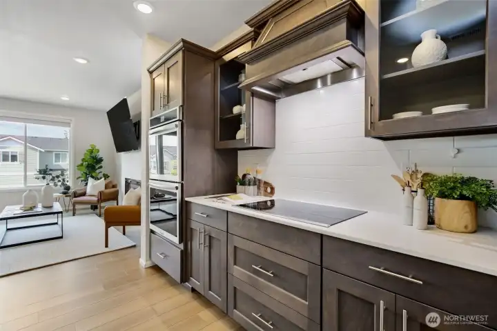 Induction cooktop, double wall ovens, and glass door upper cabinets. Induction cooktop, double wall ovens, and glass door upper cabinets.