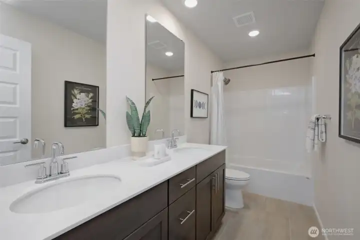 Second full bathroom on top floor with double sink and quartz counters. Second full bathroom on top floor with double sink and quartz counters.