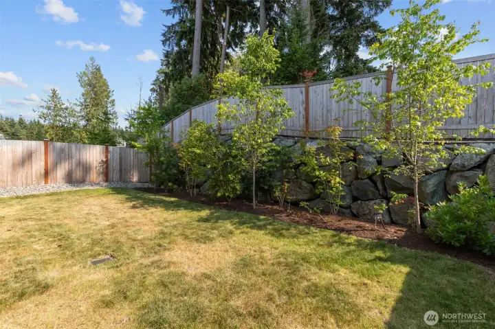 Large and level back garden, fully fenced with beautiful landscaping. Large and level back garden, fully fenced with beautiful landscaping.