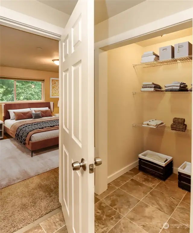 Walk-in closet in the primary suite has room for everything. This photo has been virtually staged.