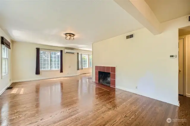 Once inside you'll see the original hardwood floors and the wood burning fireplace.