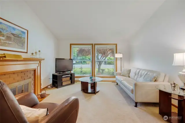 Light-filled Living Room w/ full length windows & cozy gas fireplace